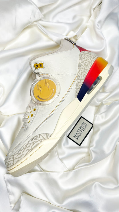 Air Jordan 3 "J. Balvin" sneakers sitting on top of luxurious premium sneaker dust bags, that ensures their pristine condition for storage or traveling. Enhancing your sneaker experience with sophistication and practicality.