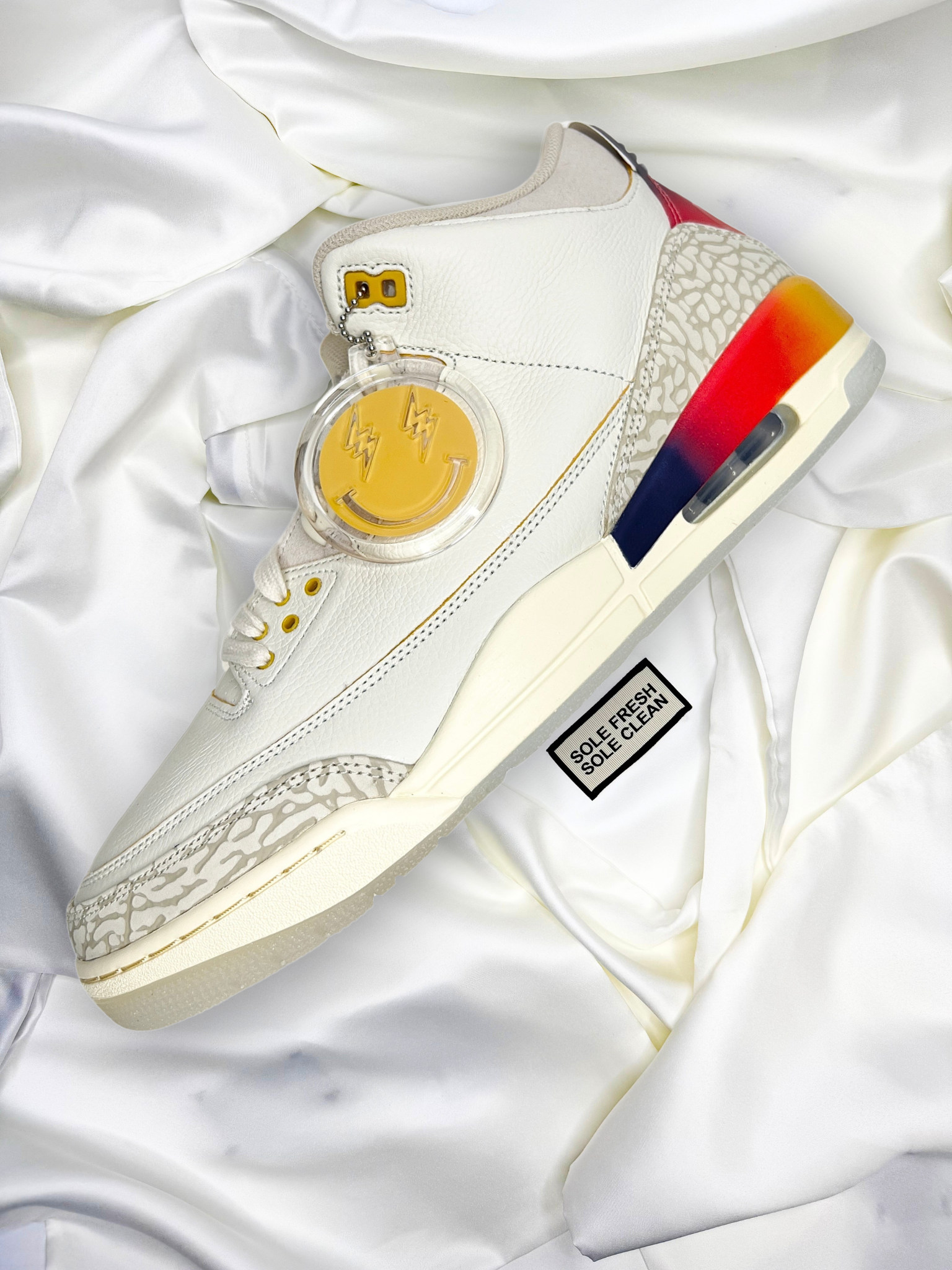 Air Jordan 3 "J. Balvin" sneakers sitting on top of the best luxurious premium sneaker dust bags, that ensures their pristine condition for storage or traveling. Enhancing your sneaker experience with sophistication and practicality.